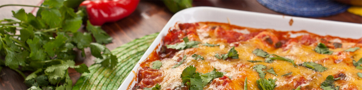 tray of turkey enchiladas in baking dish on table