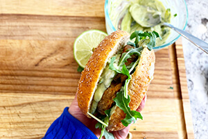 a veggie burger made with arugula and guacamole